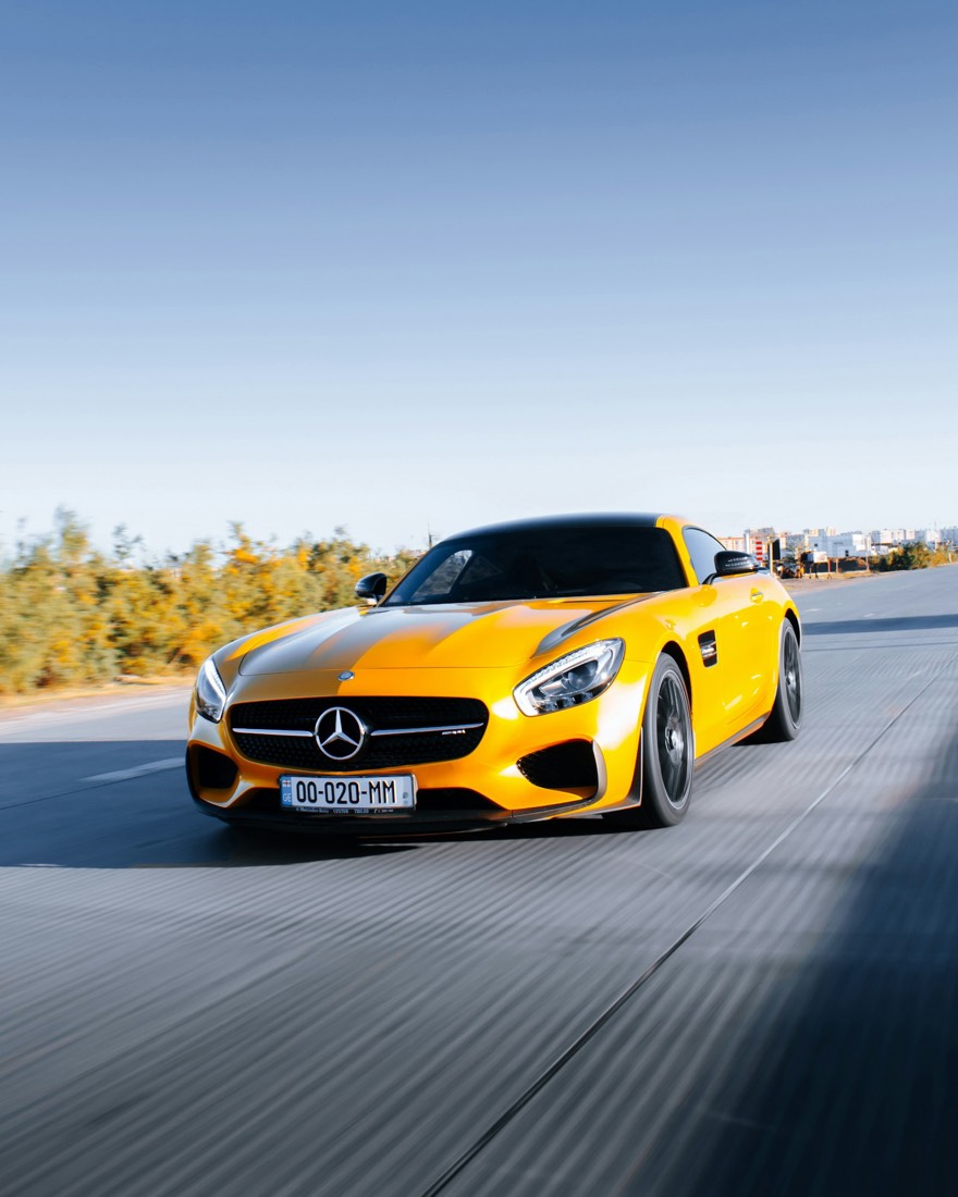 Gold grand-touring coupe with deep reflective paint after ceramic coating